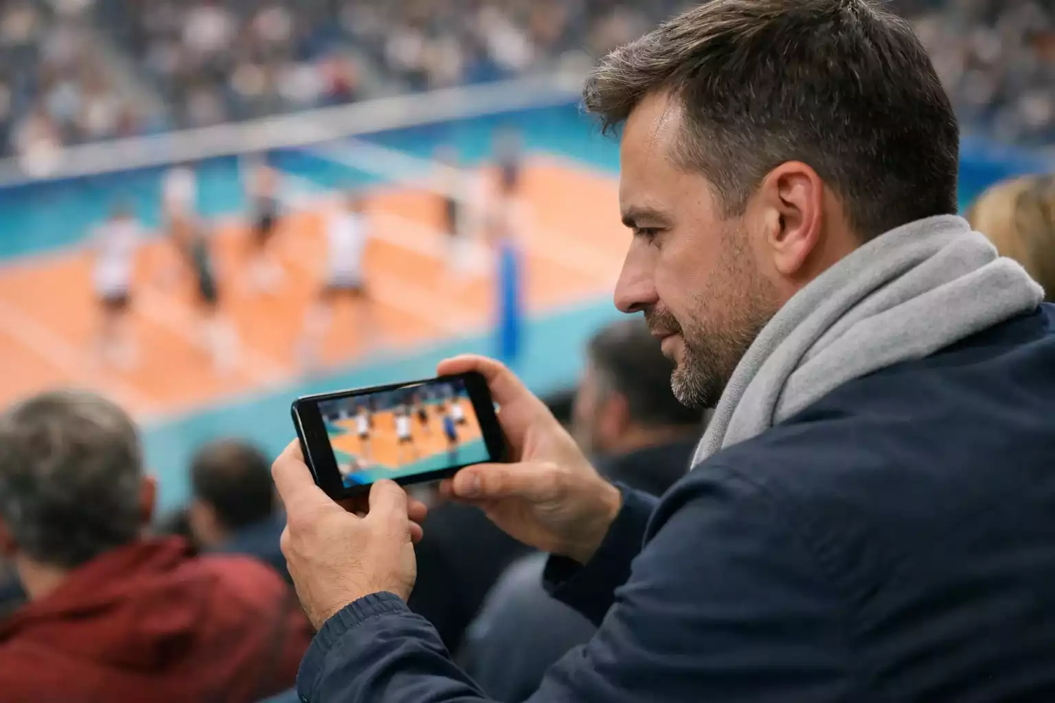 Volleyballfan schaut ein Spiel auf dem Smartphone
